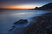 Twilight along the pebble shores of Worbarrow Bay, Jurassic Coast, UNESCO World Heritage Site, Dorset, England, United Kingdom, Europe