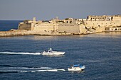 Fort Ricasoli from Valletta, with yacht and water taxi passing, Malta, Mediterranean, Europe