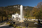 Linderhof Castle with fountain in pond and Alps behind, Bavaria, Germany, Europe