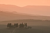 Dawn at Penella, a farmhouse surrounded by cypress trees and the misty hills of Val d'Orcia near Pienza, UNESCO World Heritage Site, Tuscany, Italy, Europe