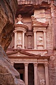 The facade of the Treasury (Al Khazneh) carved into the red rock with the Siq in the foreground, Petra, UNESCO World Heritage Site, Jordan, Middle East