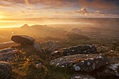 Sunrise over a misty moor viewed from Littaford Tor, Dartmoor, Devon, England, United Kingdom, Europe