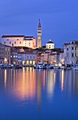 The lights of Piran harbour at dusk, Slovenia, Europe