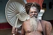 Joranda monk wearing tree bark cloth, holding palm leaf fan, with uncut hair piled up on top of his head, Joranda, Orissa, India, Asia