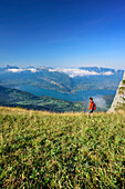 Woman hiking looking towards Lac d'Annecy, La Tournette, Haute-Savoie, France