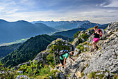 Two persons hiking at Ettaler Manndl, Zugspitze in background, Ettaler Manndl, Ammergauer Alps, Upper Bavaria, Bavaria, Germany