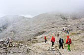 Several persons hiking on Pala plateau, Pala range, Dolomites, UNESCO World Heritage Dolomites, Trentino, Italy