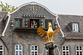 imperial eagle on fountain at market square, Glockenspiel with miners figures in facade, Goslar, Lower Saxony, Germany