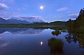 Full moon reflecting in lake Barmsee, view to Soierngruppe and Karwendel, Werdenfels region, Bavaria, Germany