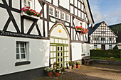 Half-timbered house in the village Kirchveischede, near Lennestadt, Rothaargebirge, Sauerland region, North Rhine-Westphalia, Germany