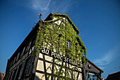 Restaurant facade covered in climbing plants in the tanner quarter, Petite France, Strasbourg, Alsace, France