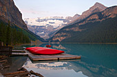 Victoria Glacier and canoes on Lake Louise, Sunrise, Banff National Park, Rocky Mountains, Alberta, Canada