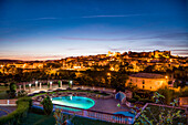 View towards old town, castle and cathedral at dusk, Silves, Algarve, Portugal