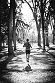 A young man jogs in a park.