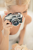 Bride photographing with vintage camera