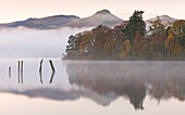 Early morning autumn mist over Derwent Water, Lake District National Park, Cumbria, England, United Kingdom, Europe