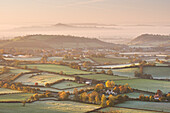 Dawn view over misty Somerset Levels countryside towards Glastonbury Tor in autumn, Somerset, England, United Kingdom, Europe