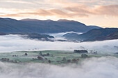 Mist covered rolling landscape at dawn in autumn, Lake District, Cumbria, England, United Kingdom, Europe