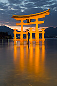 The floating Miyajima torii gate of Itsukushima Shrine at dusk, UNESCO World Heritage Site, Miyajima Island, Western Honshu, Japan, Asia