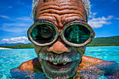 Portrait of local fisherman in the water wearing goggles, Jaco Island, Timor-Leste