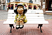 Mafalda, Famous 6 Year Old Cartoon Character, Sitting On A Bench In Defensa, San Telmo, Buenos Aires, Argentina