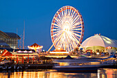 Chicago, Illinois Boat Pull Away From Dock At Navy Pier At Night, Ferris Wheel And Skyline Stage