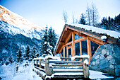 Winter alpine scenery with mountains, snow and a pine forest with Brekke rental cabins, Ortnevik, Sognefjord, Norway