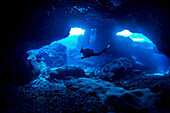 Diving into one of the underwater caves that surround Niue, Niue Island
