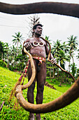 Pentecost Land diver with land diving tower in the background, Pentecost Island, Vanuatu