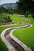'A stone walled path winding through gardens; Kigali, Rwanda'