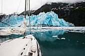 Sailboat in Prince William Sound with scenic view of tidewater glacier and mountains, Southcentral Alaska