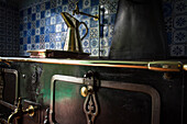 the copper pitcher on the cooker in the kitchen in blue tiles from rouen, the impressionist painter claude monet's house, giverney, eure (27), normandy, france