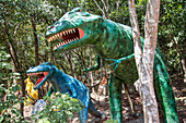 dinosaurs at the entrance to the representation of hell, wat keaw prasert, pathio, province of chumphon, thailand, asia