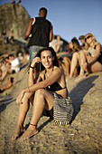 Claudia Mora at eastern part of Praia de Ipanema, in the evening, spectators on Pedra do Arpoador (Harpooner`s Point), Ipanema beach, Rio de Janeiro, Rio de Janeiro, Brazil