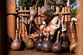 Camdodia, Ratanakiri Province, Phomkres village, Pot At draws water from the only village fountain to fill up her traditional calabashes