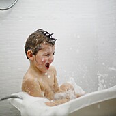 A little boy taking a bath