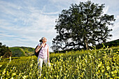 Caucasian woman standing in tall grass