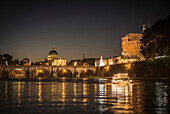 Illuminated bridge over river, Rome, Italy