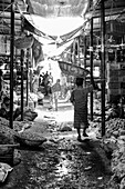 Man carrying basket on his head at a local market, Dhaka, Bangladesh