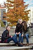 3 girls chatting outside in Hafencity, Hamburg, Germany, Europe