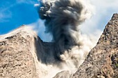Close up, Time exposure of a large ash eruption of the active volcano Batu Tara during the day,  , island of Komba, Flores Sea, Indonesia