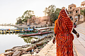 Indian woman walking at waterfront
