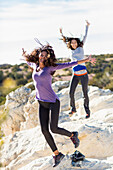 Hikers cheering on rocky hilltop