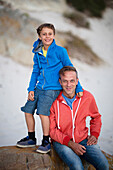 Caucasian father and son smiling on beach