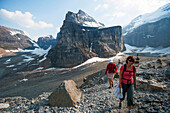Caucasian mother and daughter hiking on Six Glaciers Trail, Banff, Alberta, Canada