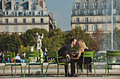 Caucasian couple kissing near fountain in urban park, Paris, Ile-de-France, France