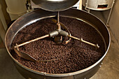 Coffee beans roasting in industrial kettle