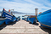 Blue boats docked on boat ramp