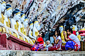 Asian family praying at Buddha temple