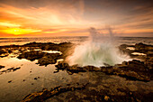 Ocean waves crashing in Thor's Well at sunset, Cape Perpetua, Oregon, United States